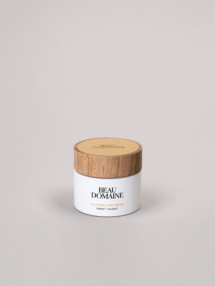 White jar with wooden lid labeled 'Beau Domaine' on a light gray background